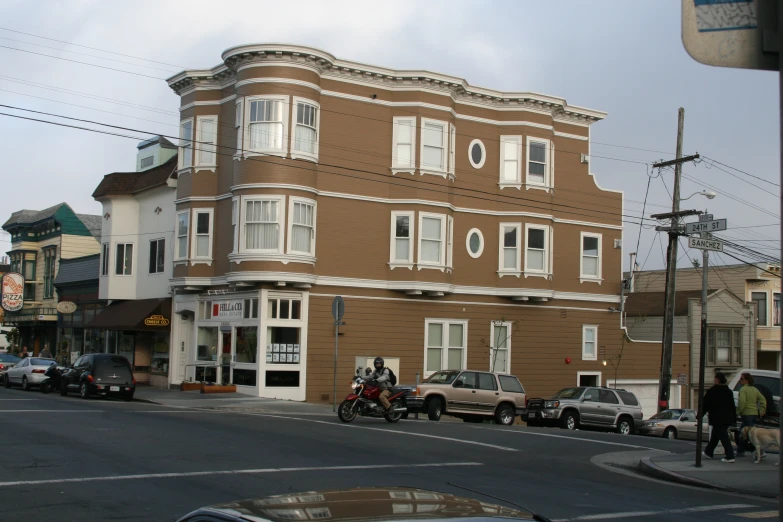 cars on a city street by an old building