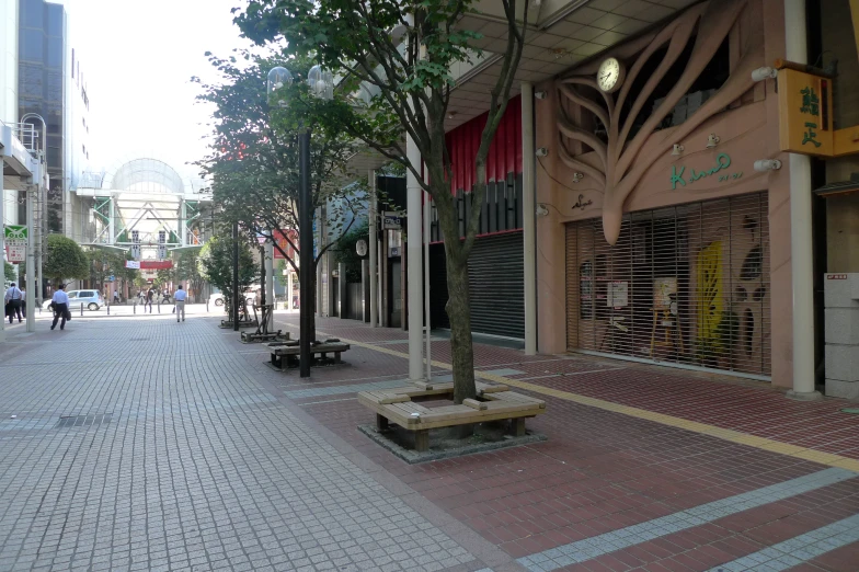 people are walking around on a sidewalk near shops