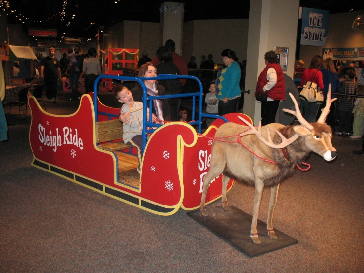 reindeer sitting inside a small child's sleigh ride