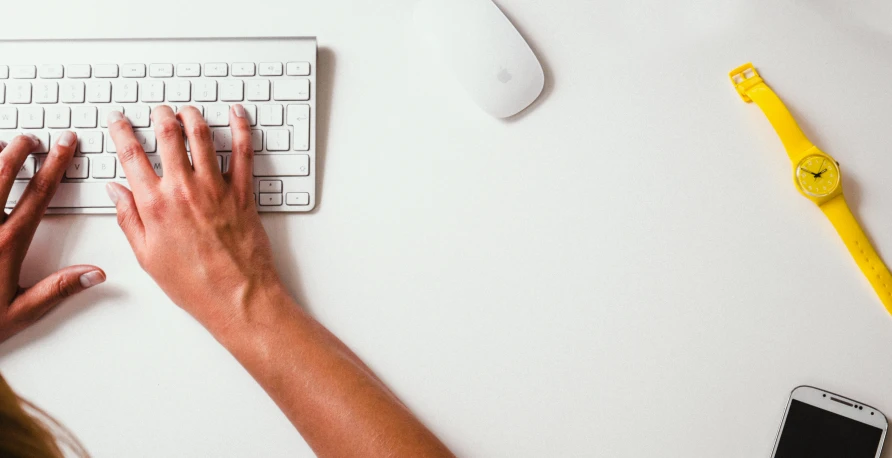 a woman is typing on her computer keyboard