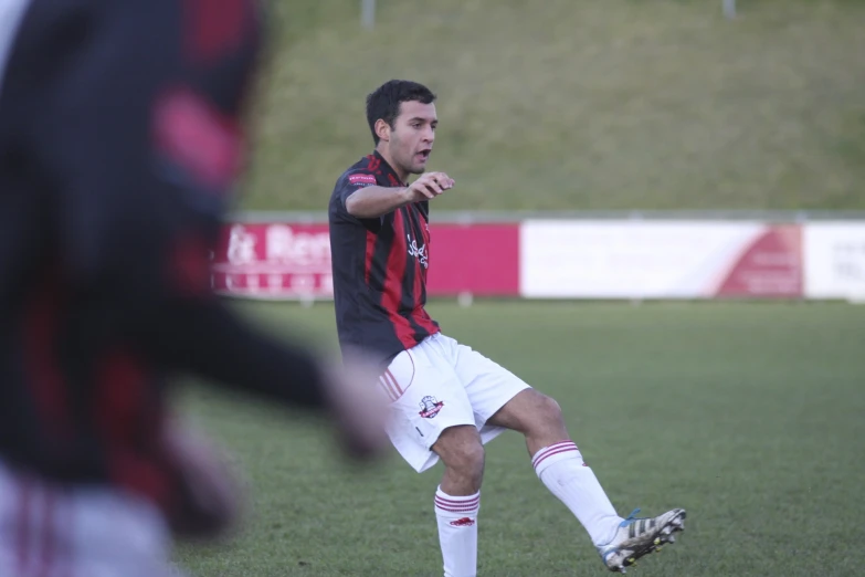 a young man holding a soccer ball in his hand