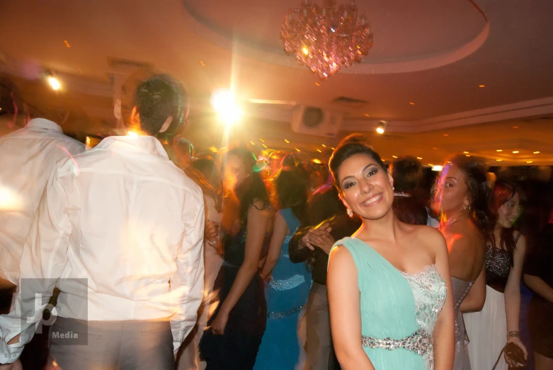 a woman is at a dance in front of many other people