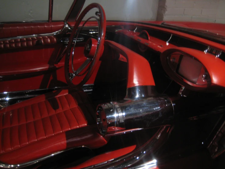 the interior of a car, with red leather and chrome