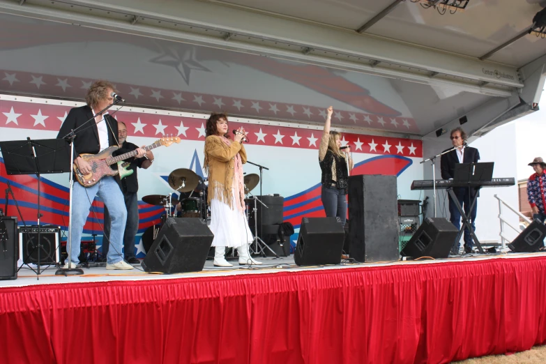 a band on stage with people in costumes