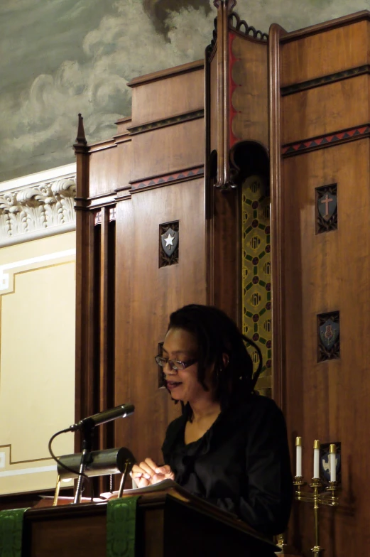 a person sitting at a podium and talking