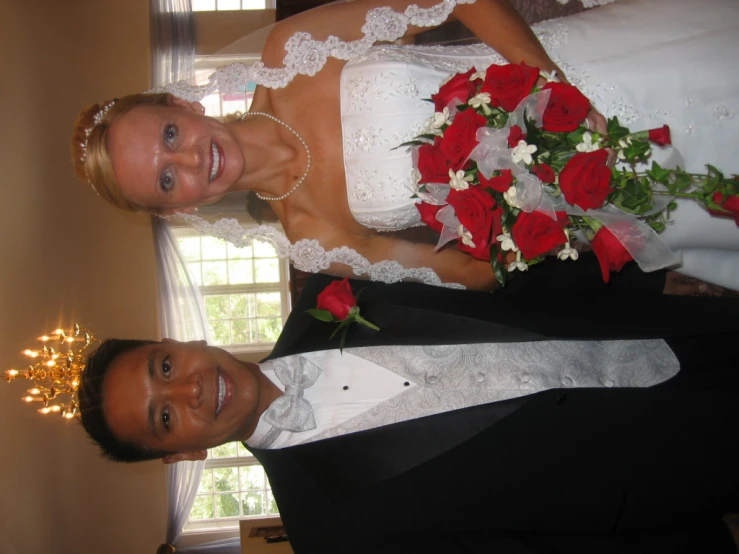 a man in a tuxedo and woman in wedding dress holding a bouquet