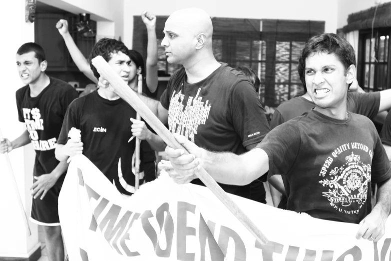 a group of young men holding a banner