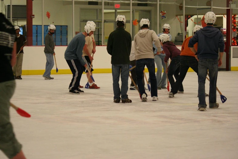 a group of people play curling on an indoor rink