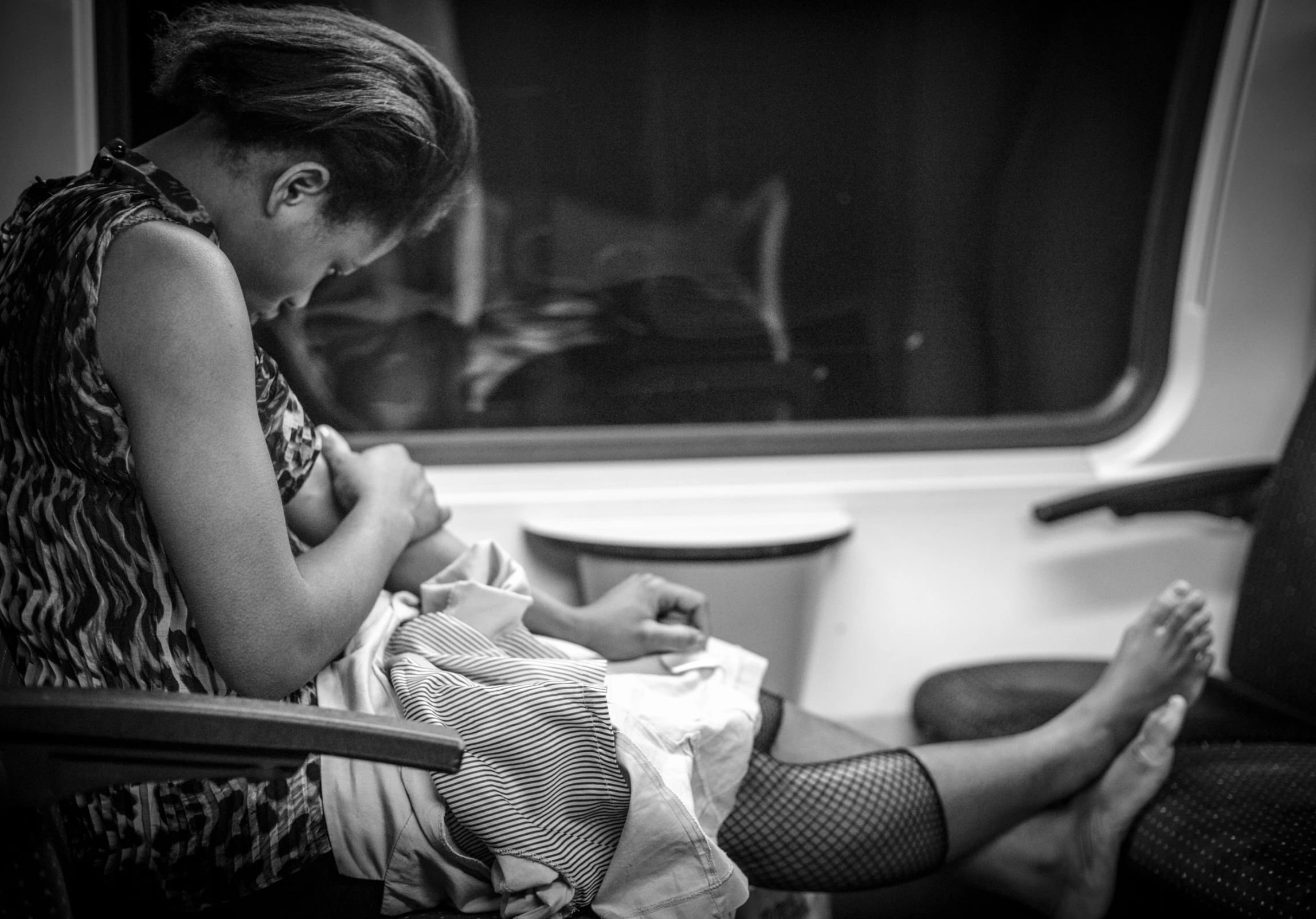 two women sitting by each other on the train