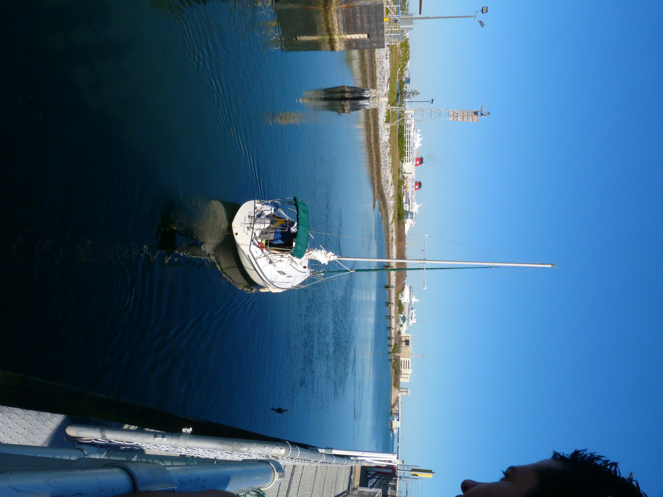 the man is standing next to a boat in the water