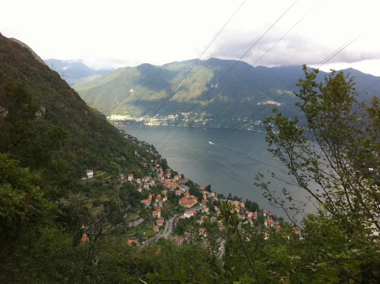 a mountain town on the side of a cliff near the ocean