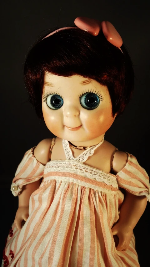 an antique doll with blue eyes and hair