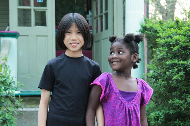 two young children standing next to each other