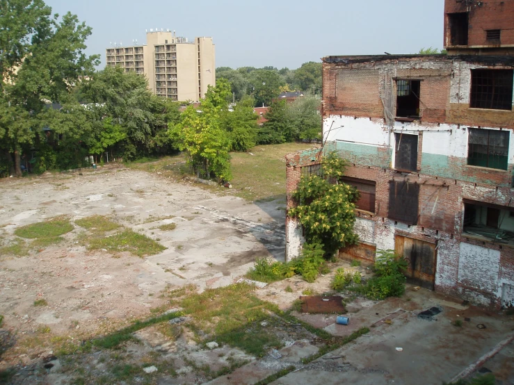 an empty building with several windows surrounded by trees