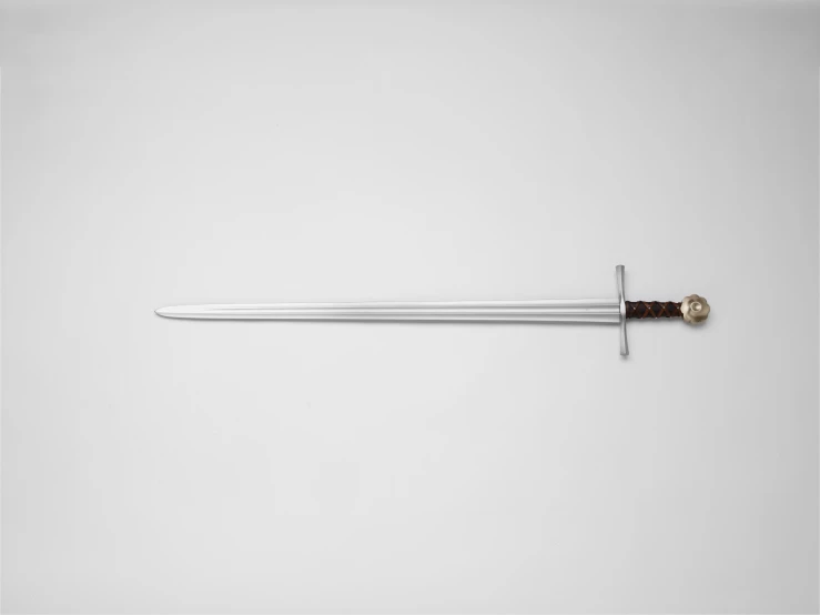 a large metal sword on a white surface