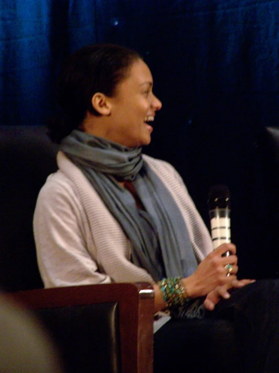 a woman holding a bottle with the word on it