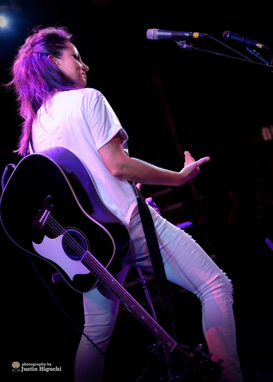 a person on a stage with an electric guitar