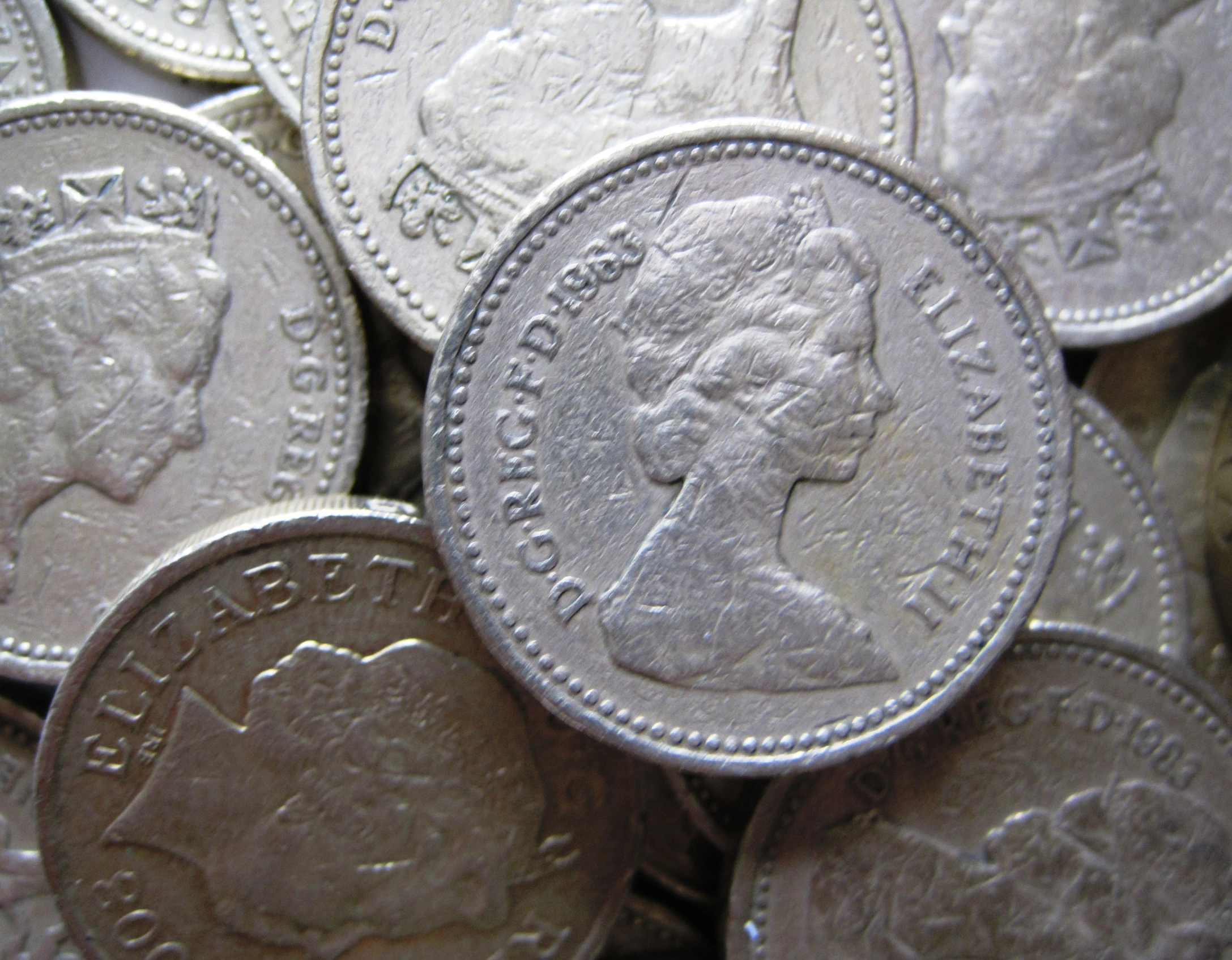 a bunch of old british silver coin with some on it