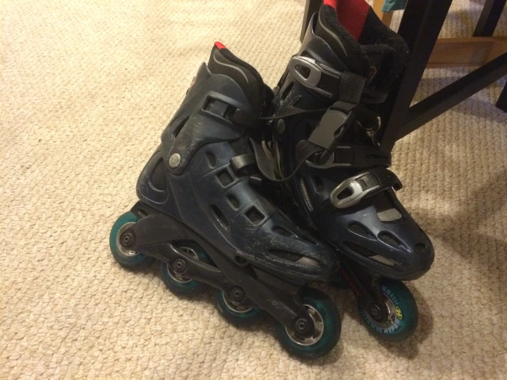 two roller skates are positioned on a carpet