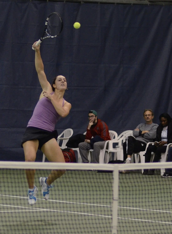 the tennis player is jumping up to hit the ball