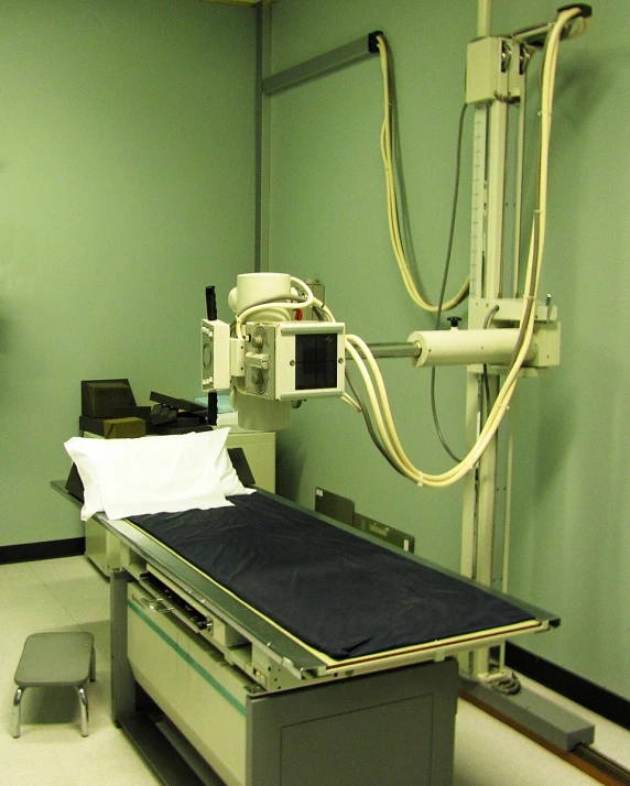 a hospital room with an iv and a table