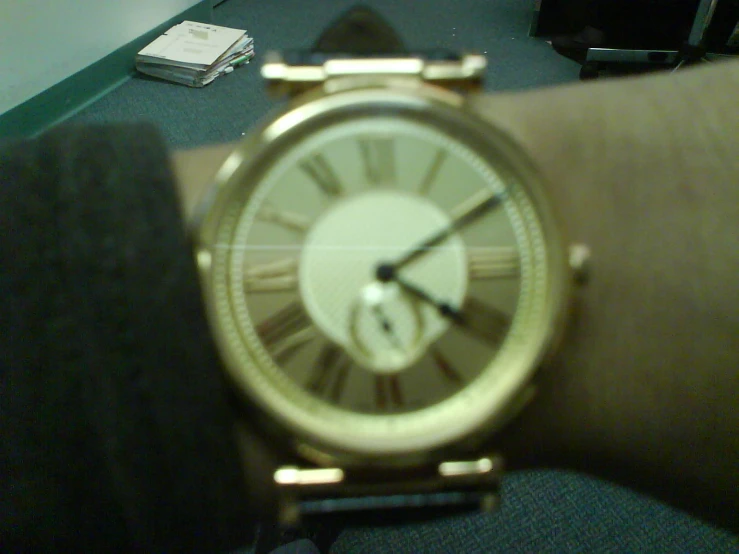 a woman watches an analog clock while on her watch celet