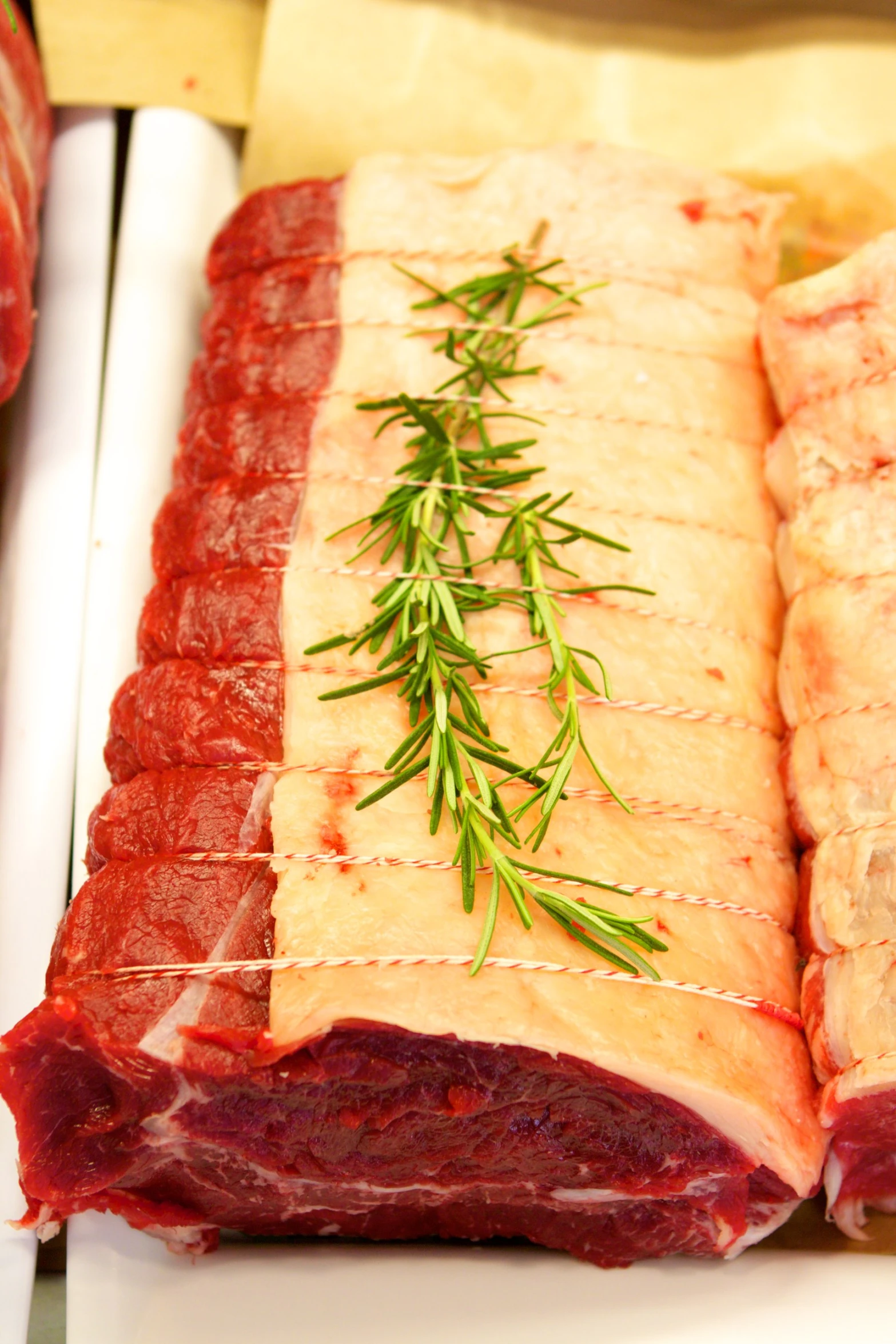 some thin sliced meat is being served on a plate