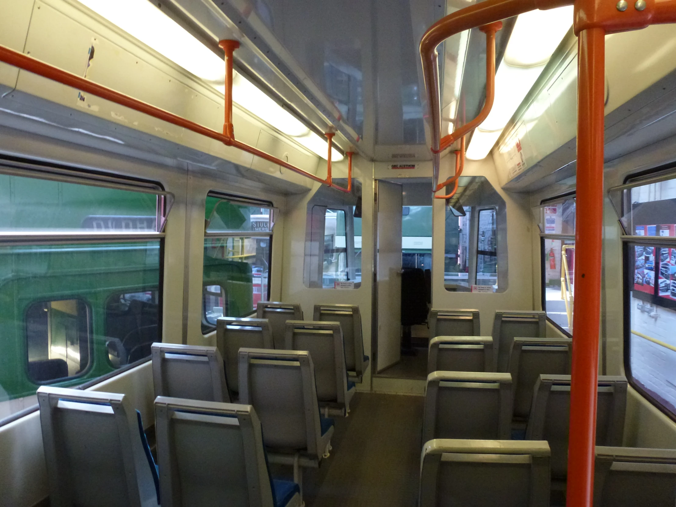 an empty train car with a large row of seats