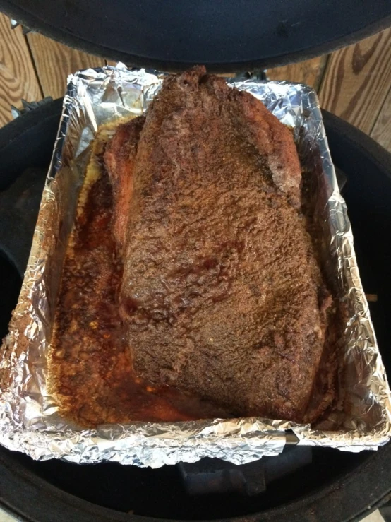 a steak in tinfoil on a grill