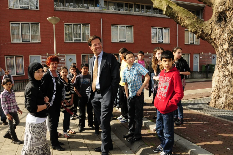 a group of people standing on a sidewalk