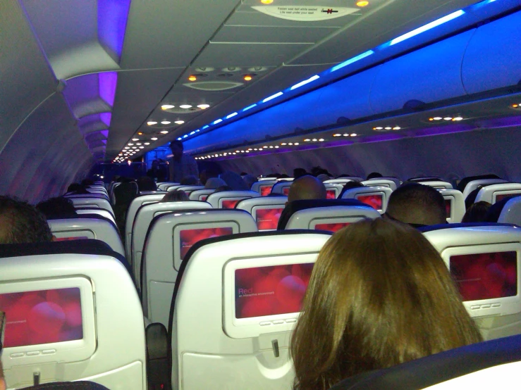 an empty airplane with a row of seats on the side