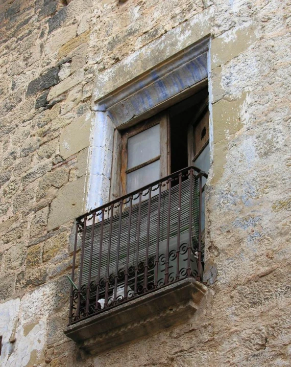 an old balcony is painted red and rusty