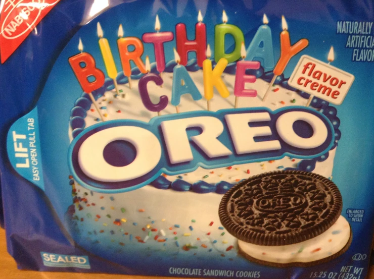 an oreo birthday cake with lit candles is pictured