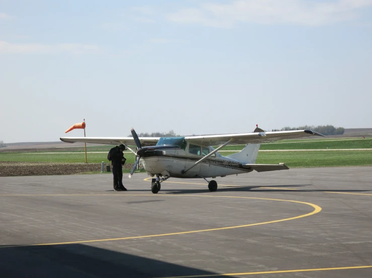 a small propeller plane parked at an airport with it's landing gear down