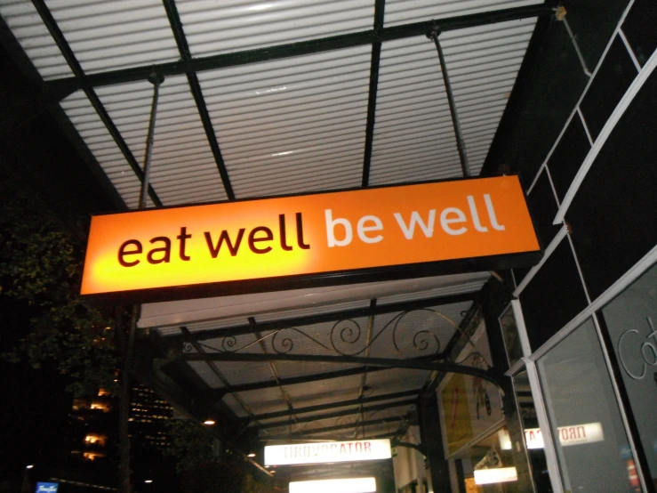 there is an orange sign that says eat well