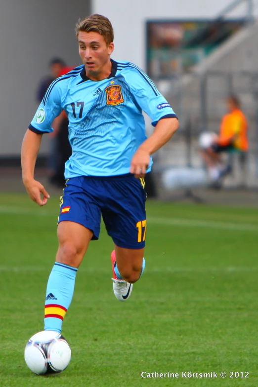 a man on a soccer field running after a ball