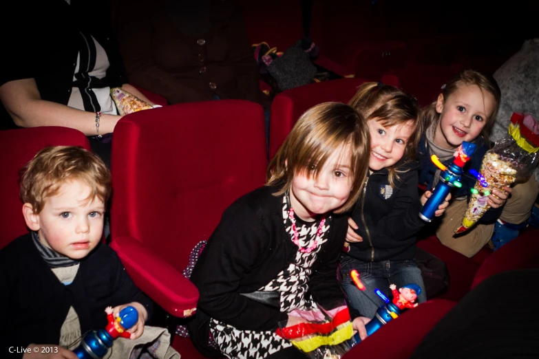 young children at an event and some people watching