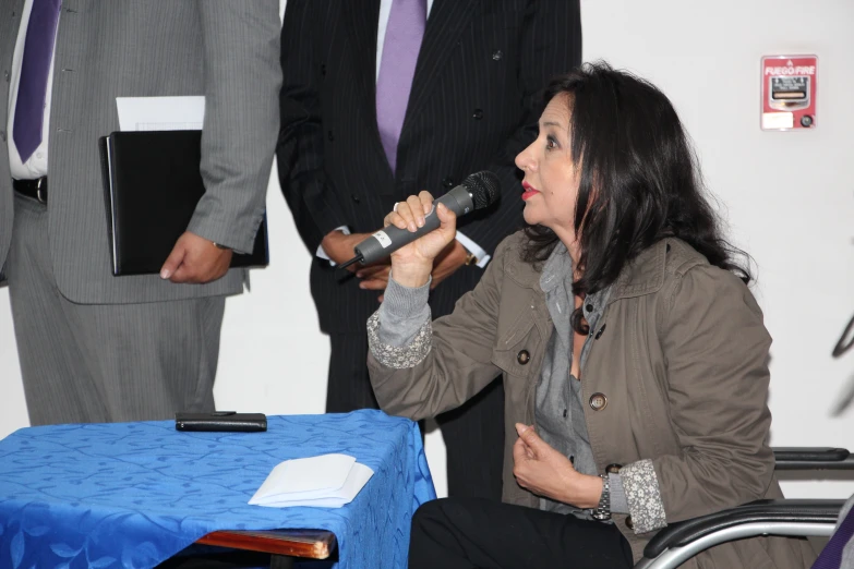 a woman in a suit and tie sitting in a chair