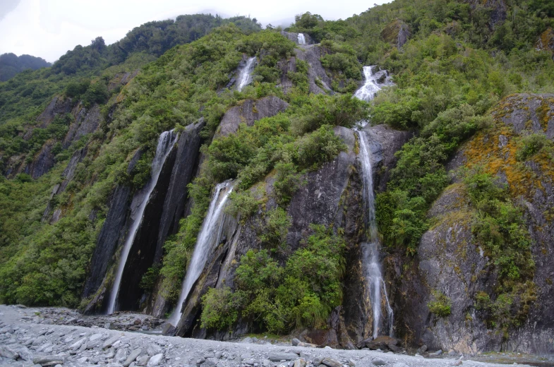 a large waterfall flowing out of a mountain