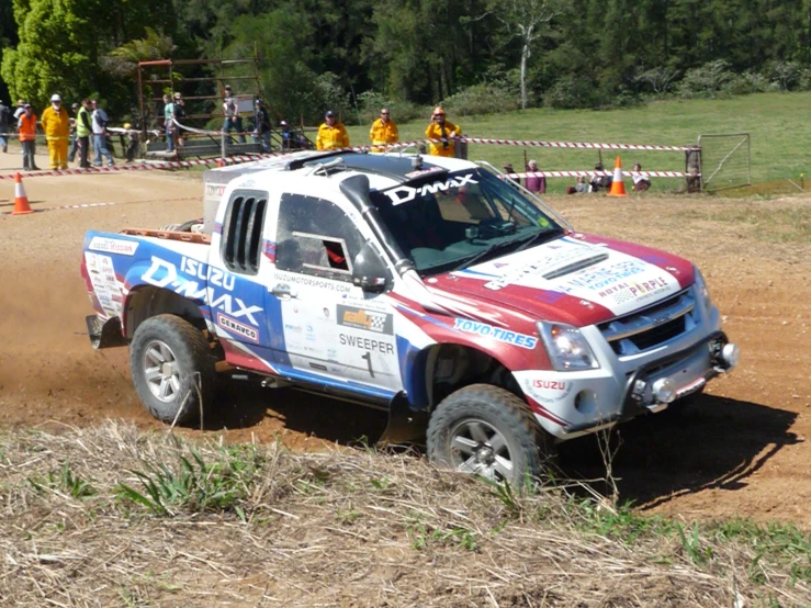 an suv that is on some dirt near trees