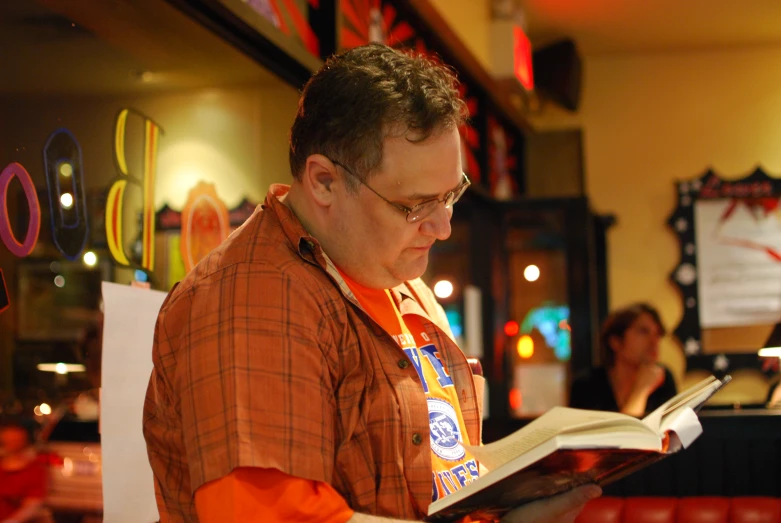 a man is reading the menu at the restaurant