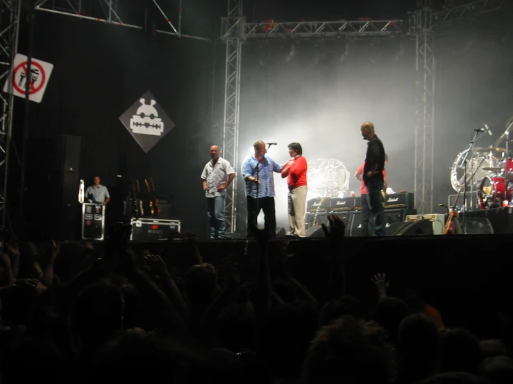 a group of men that are standing on a stage