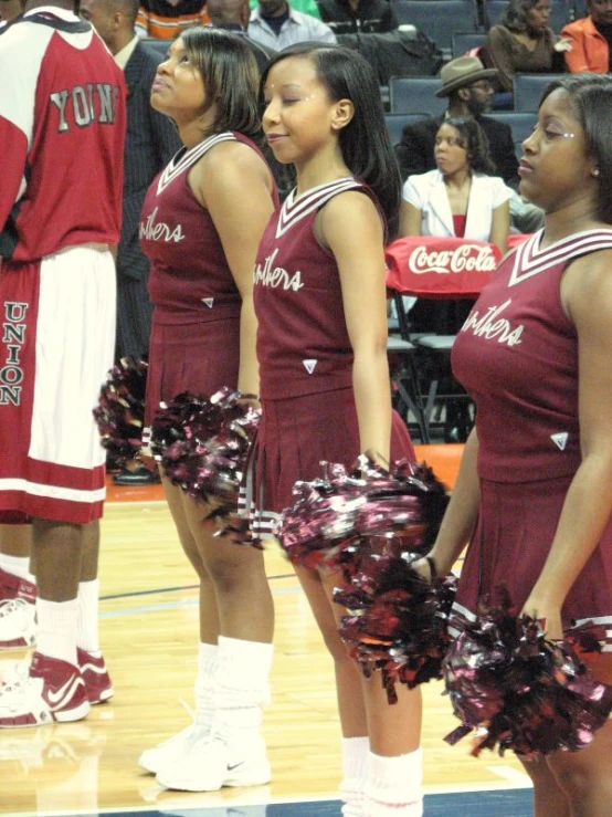 a bunch of women that are standing on a court