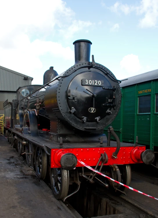 an old time train pulling into a train station