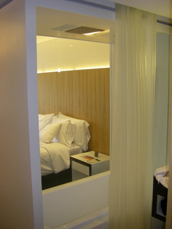 a bedroom with large white bed sitting under a window