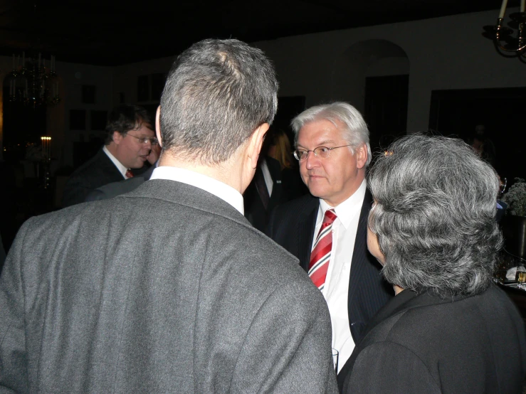 a group of people are standing around in a room