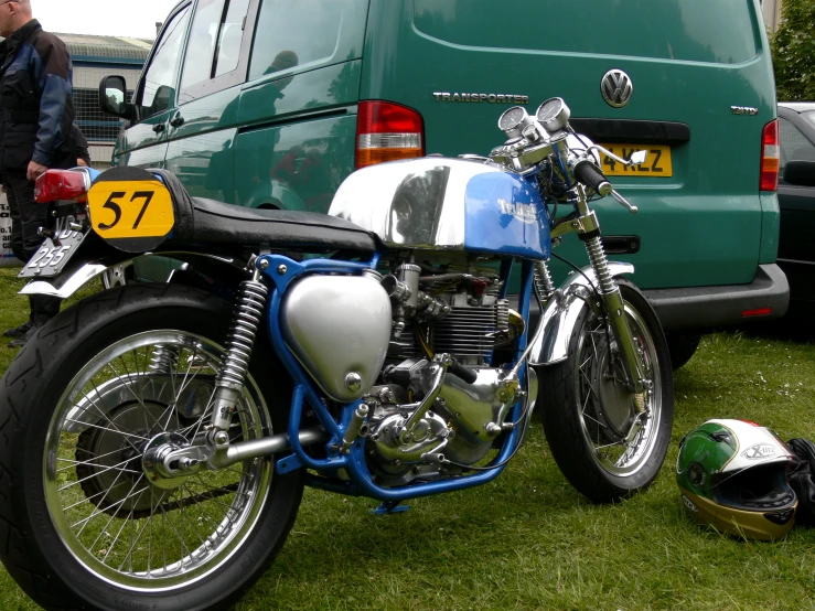 a motor cycle parked in the grass with the back wheel up