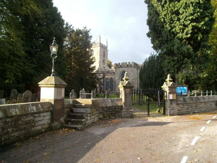 the driveway leads to the old gothic - era cemetery