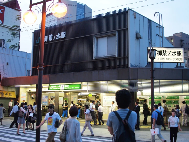 people are walking in the streets and crossing at twilight