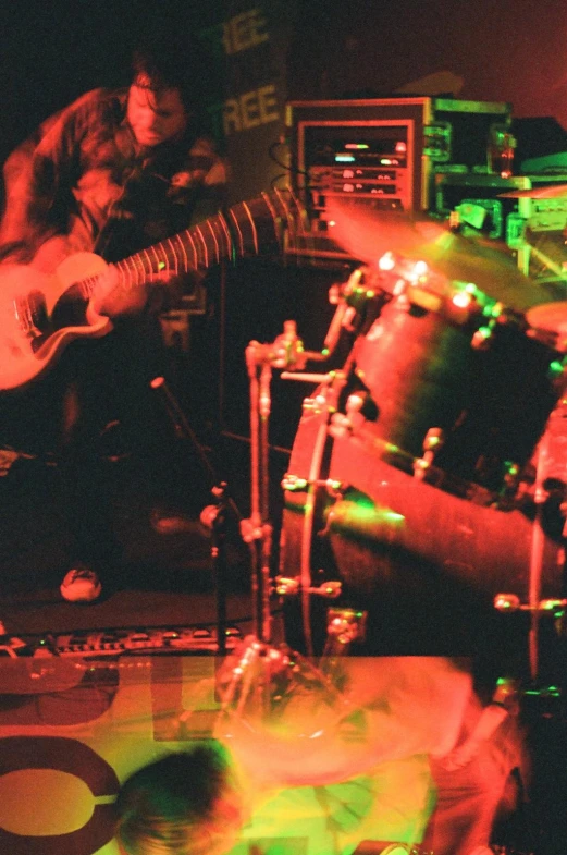 people playing instruments on a stage in the dark